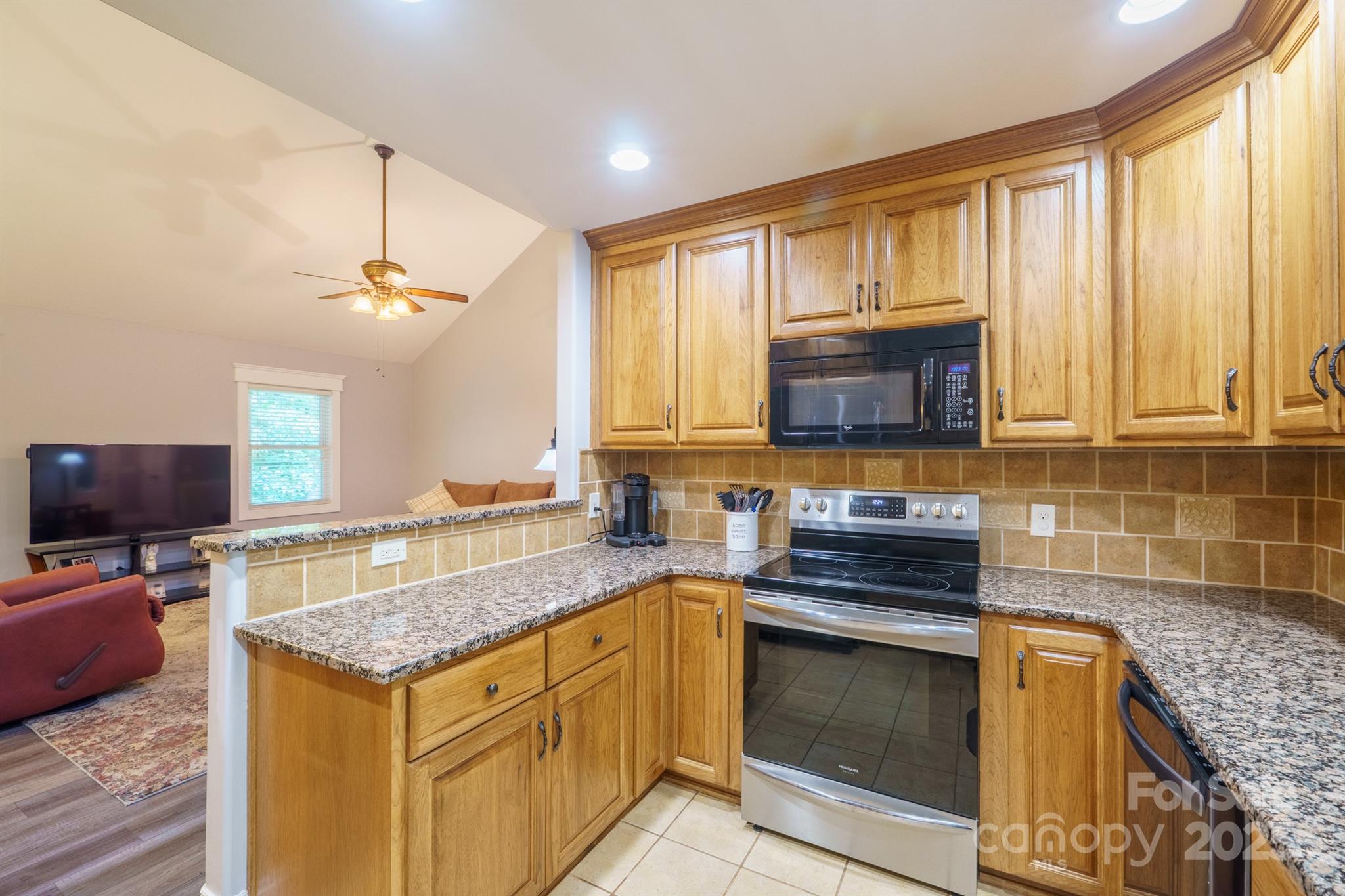 121 Jefferson Drive Locust, NC 28097 - Photo 7 of 22 a kitchen with a stove and a microwave
