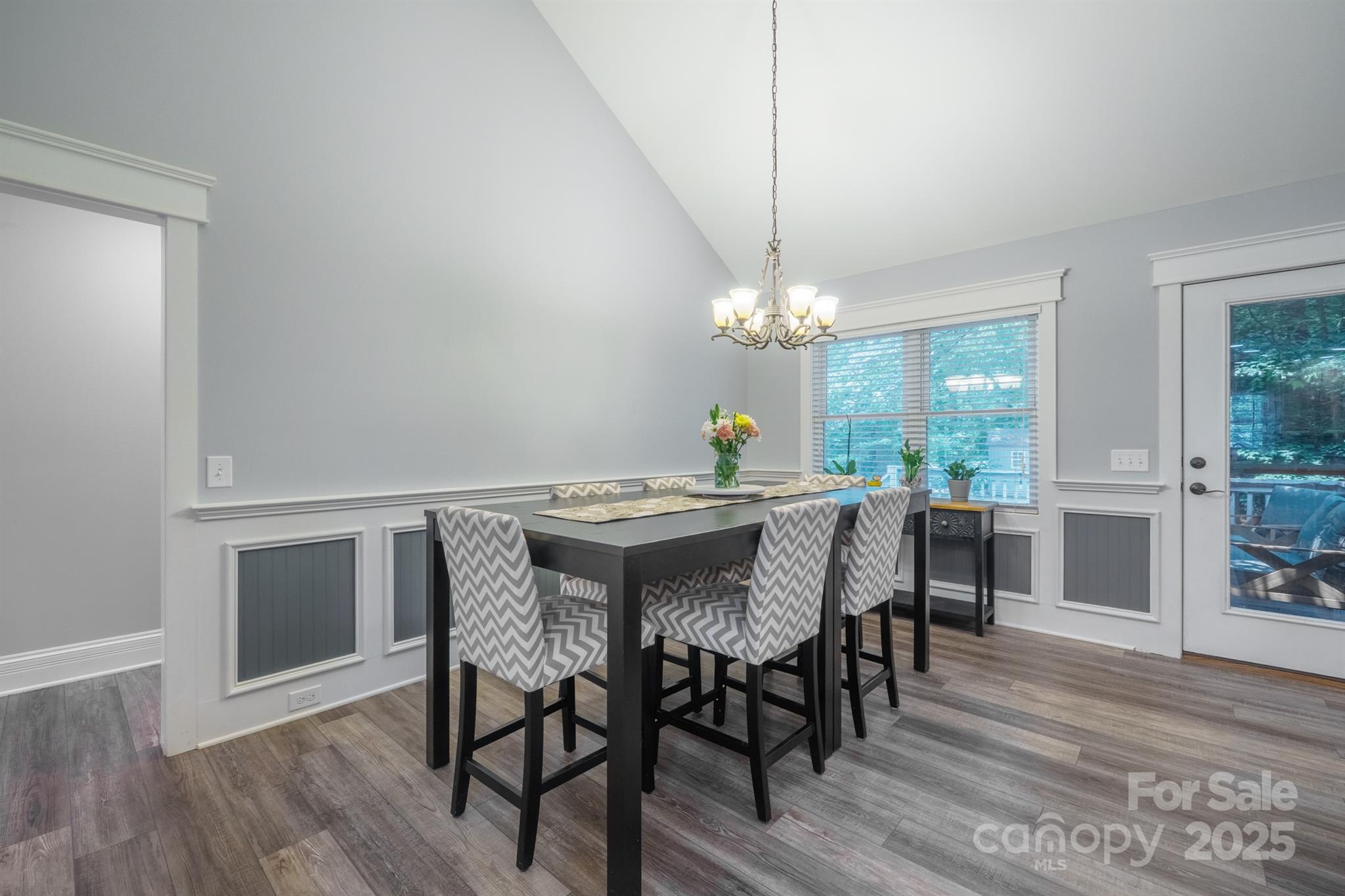 121 Jefferson Drive Locust, NC 28097 - Photo 8 of 22 a view of a dining room with furniture a chandelier and wooden floor