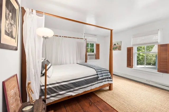 a bed sitting in a room next to a window