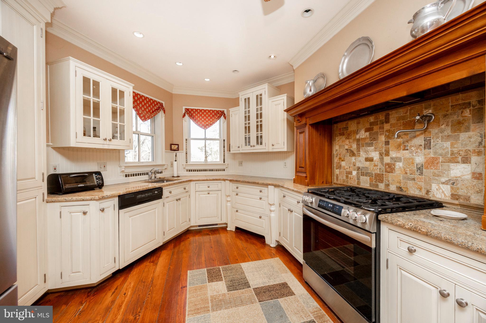 2135 Esten Road Quakertown, PA 18951 - Photo 5 of 47 a kitchen with granite countertop a stove top oven a sink a counter space and cabinets