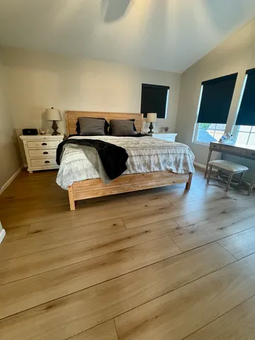 a living room with a bed furniture and a flat screen tv