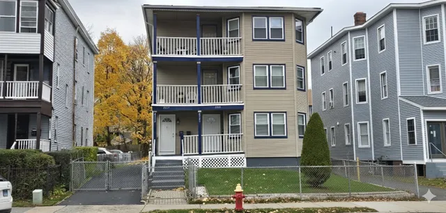 a front view of a residential apartment building with a yard