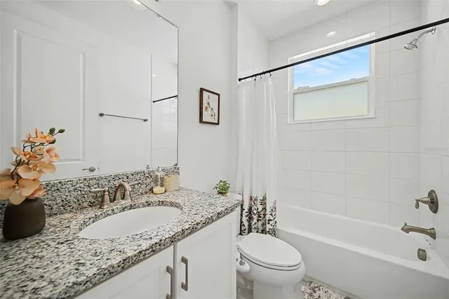 an aerial view of a house with outdoor space and lake view in back