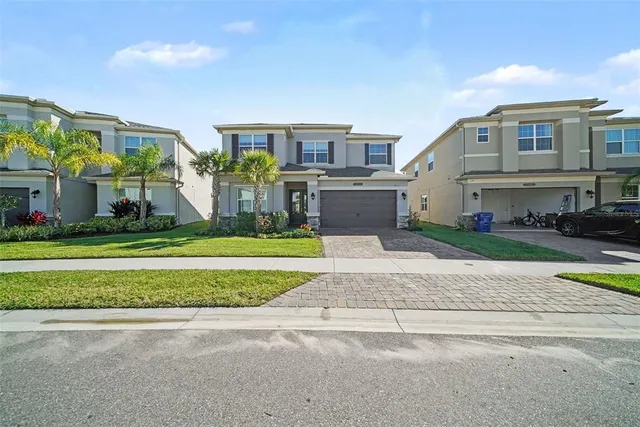 a view of a brick building next to a yard