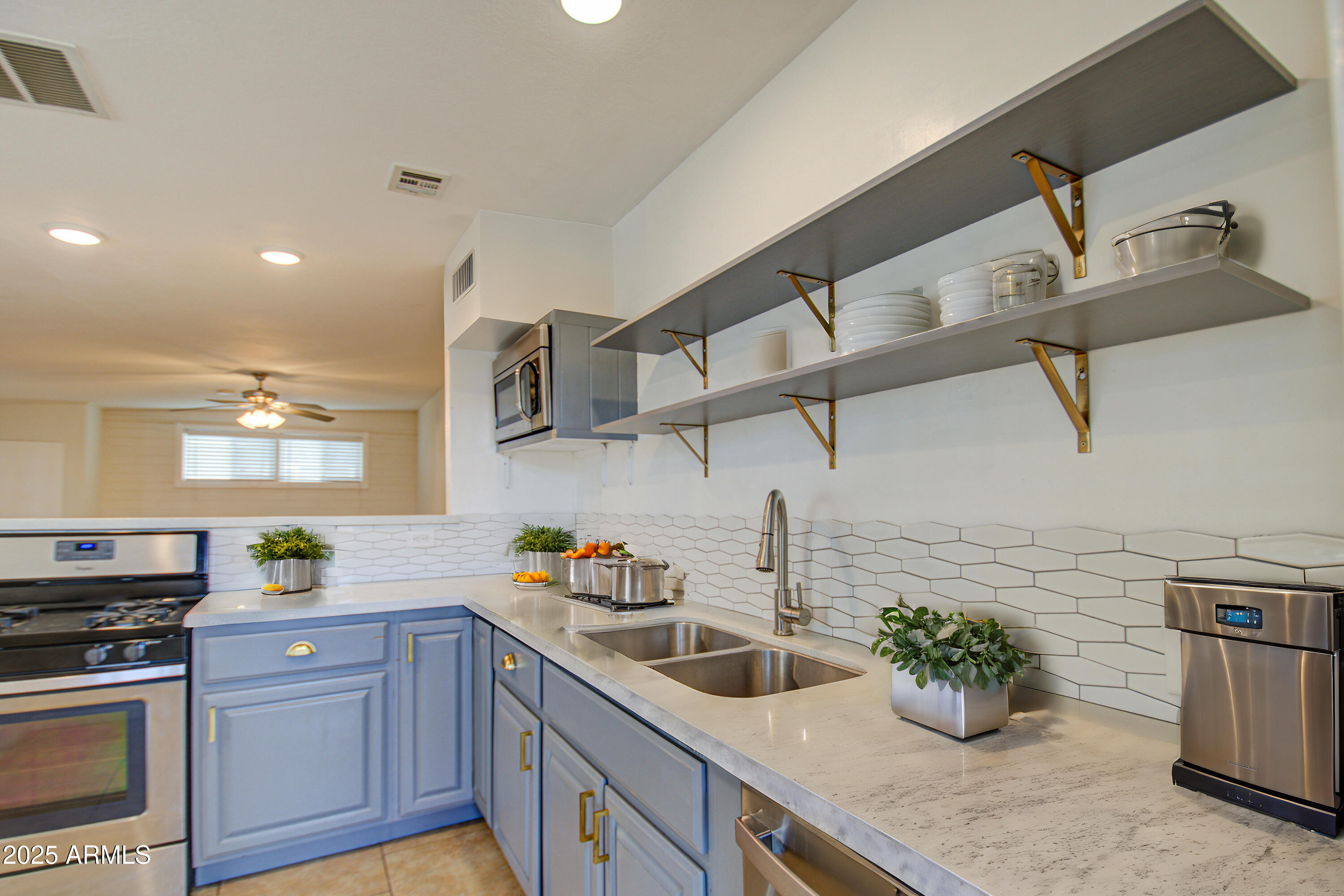 2937 East Osborn Road Phoenix, AZ 85016 - Photo 15 of 59 a kitchen with a sink a stove and cabinets