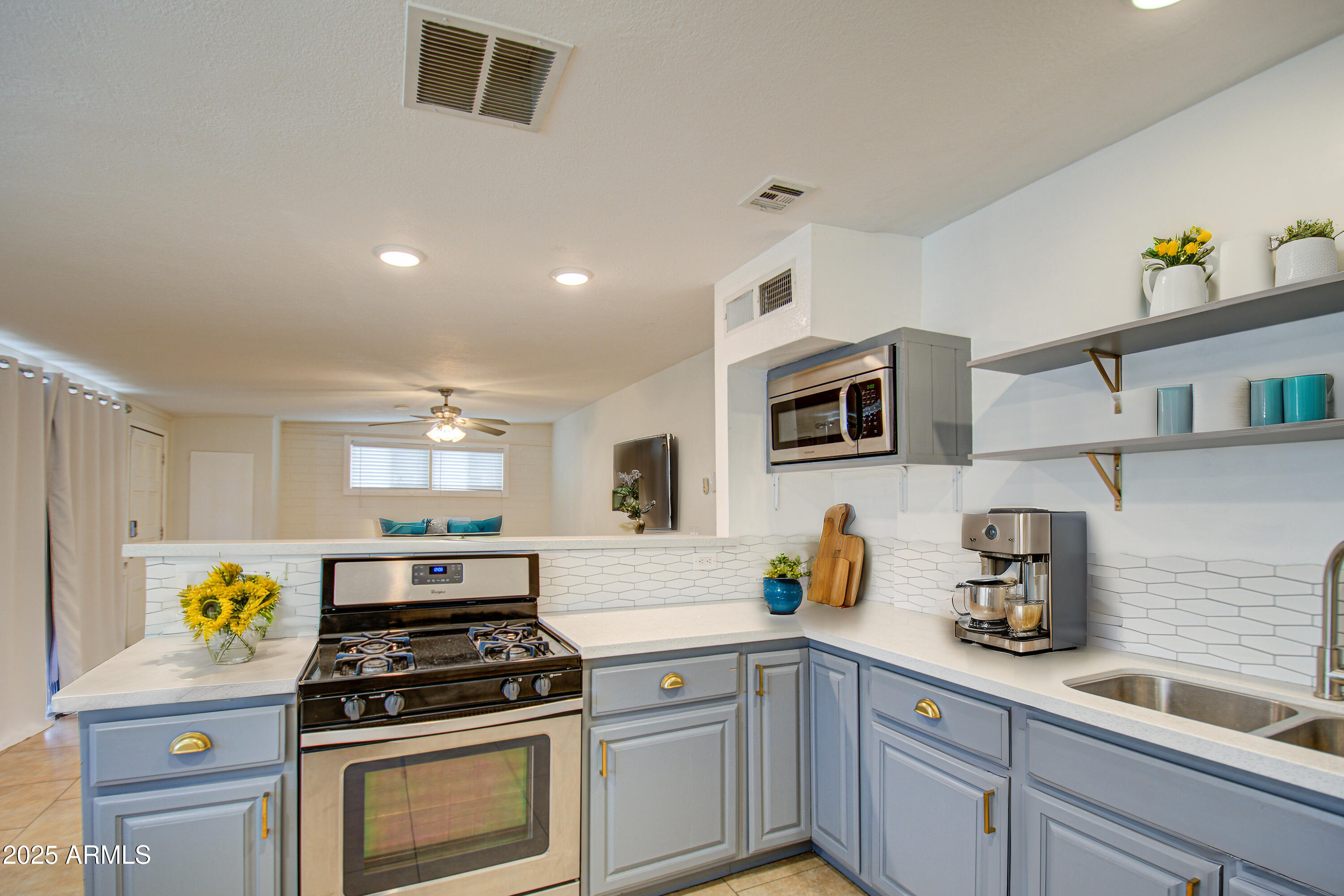 2937 East Osborn Road Phoenix, AZ 85016 - Photo 16 of 59 a kitchen with stainless steel appliances granite countertop a sink a stove and a refrigerator