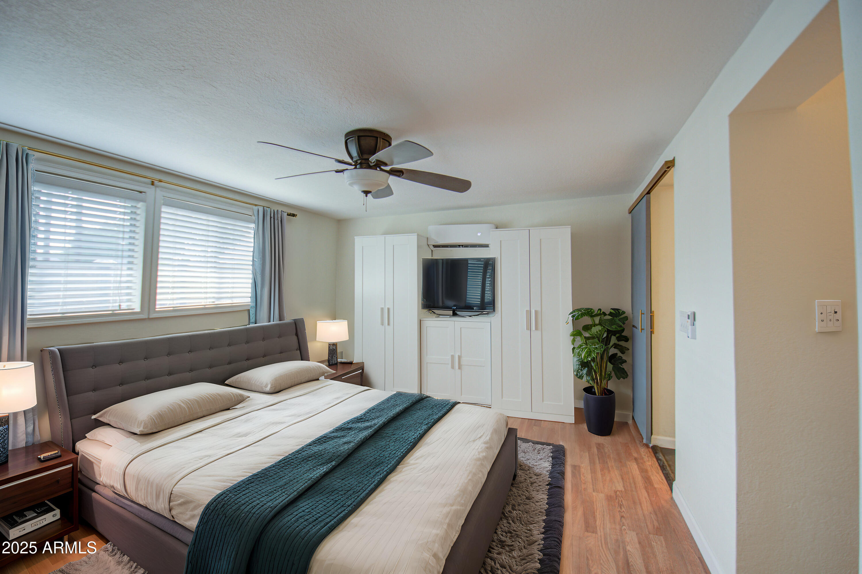 2937 East Osborn Road Phoenix, AZ 85016 - Photo 18 of 59 a bedroom with a large bed and a tv