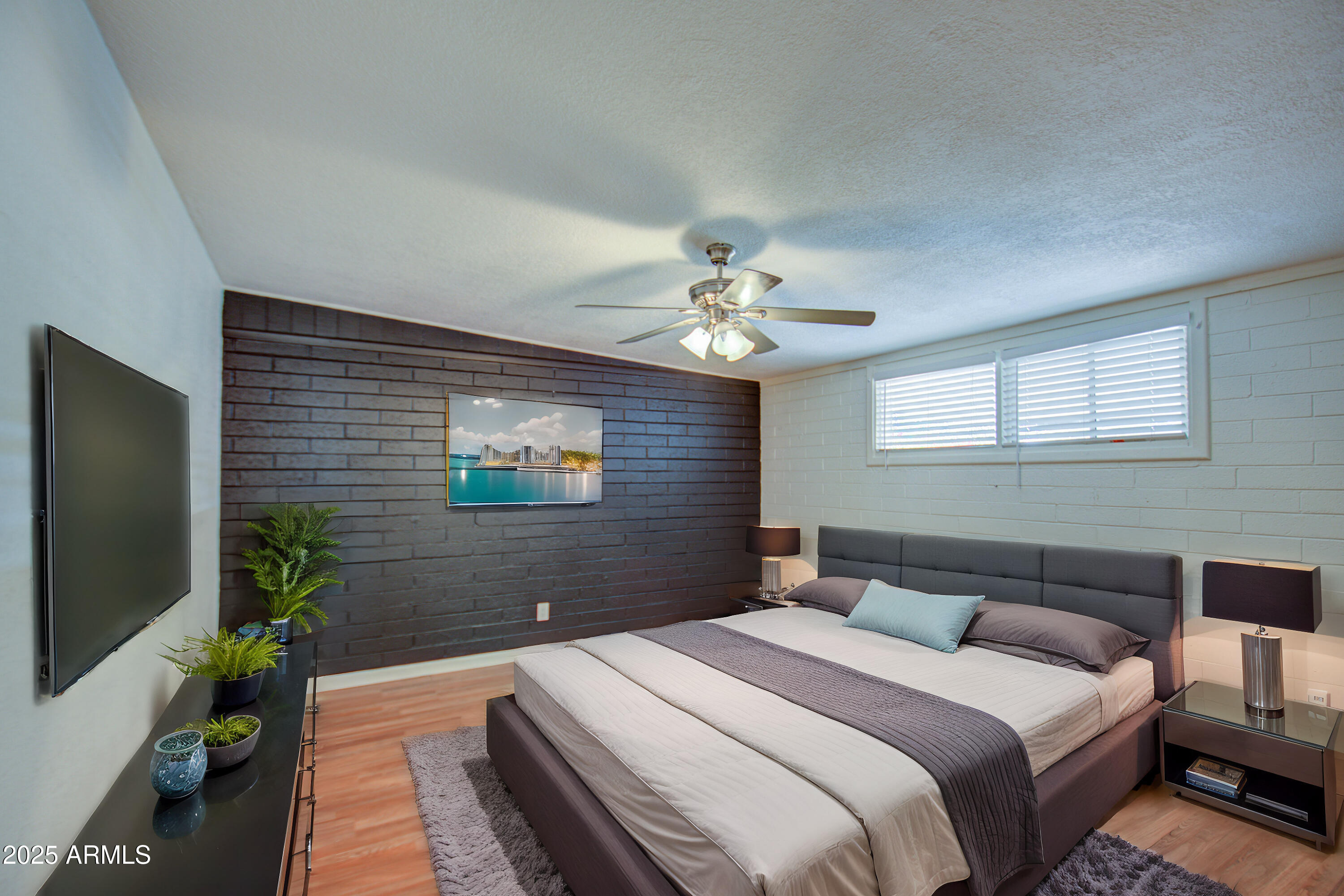 2937 East Osborn Road Phoenix, AZ 85016 - Photo 23 of 59 a bedroom with bed and a flat screen tv