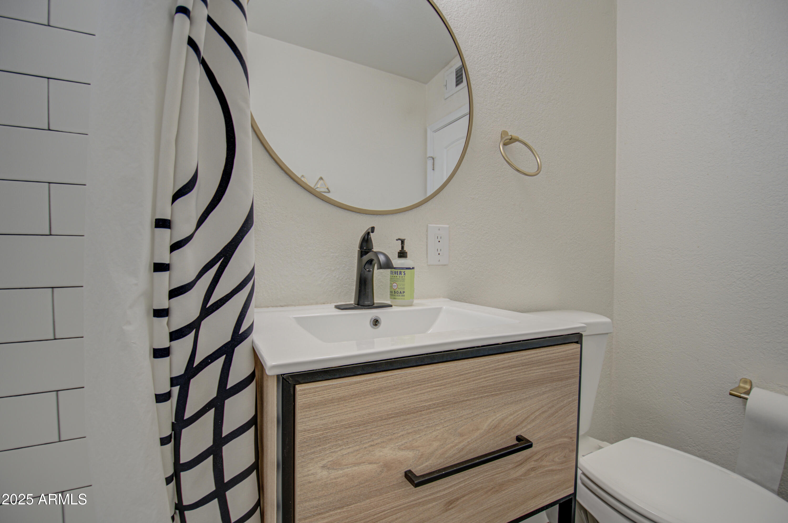 2937 East Osborn Road Phoenix, AZ 85016 - Photo 27 of 59 a bathroom with a sink a toilet and a mirror
