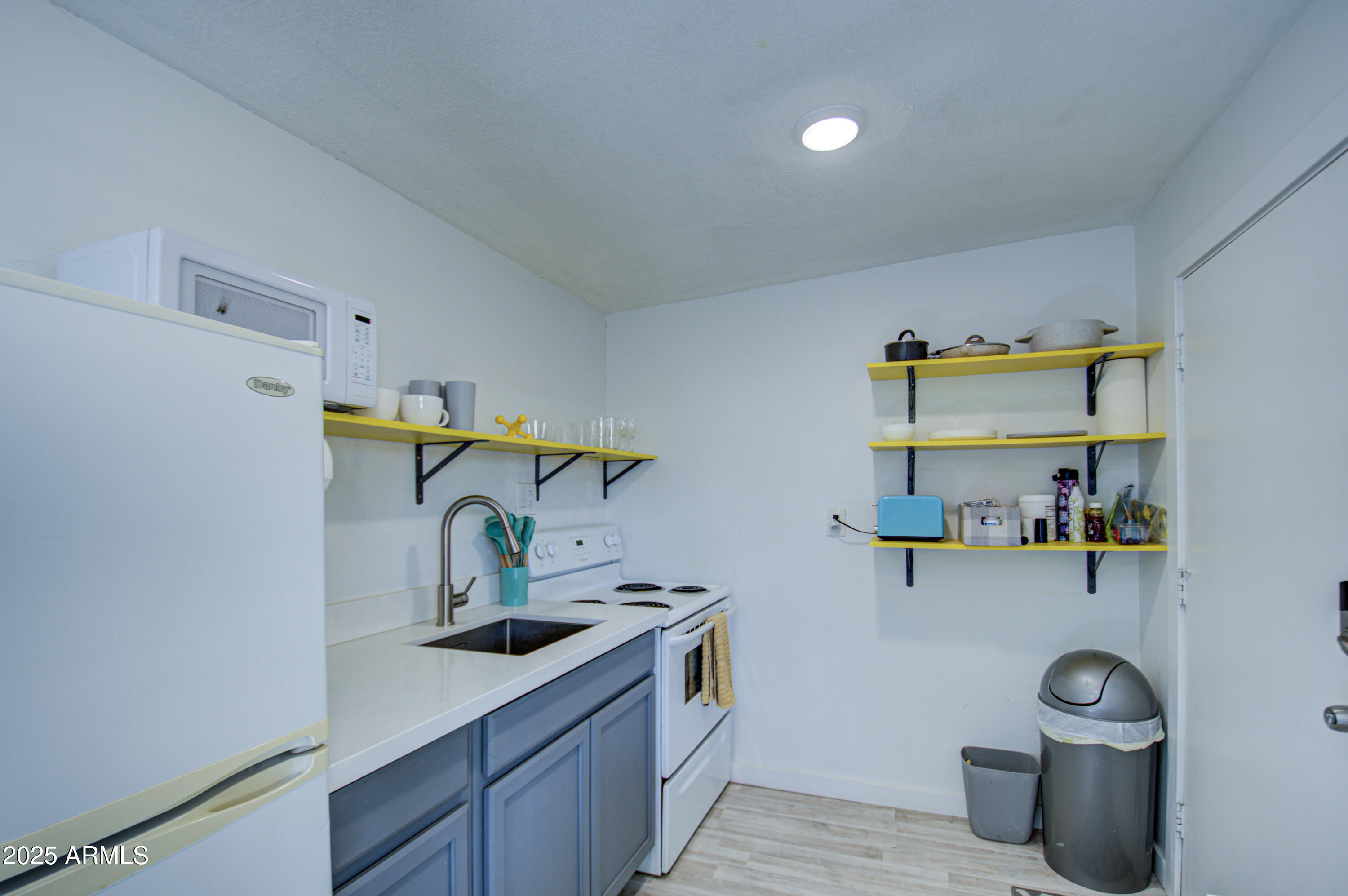 2937 East Osborn Road Phoenix, AZ 85016 - Photo 36 of 59 a kitchen with a sink and a refrigerator
