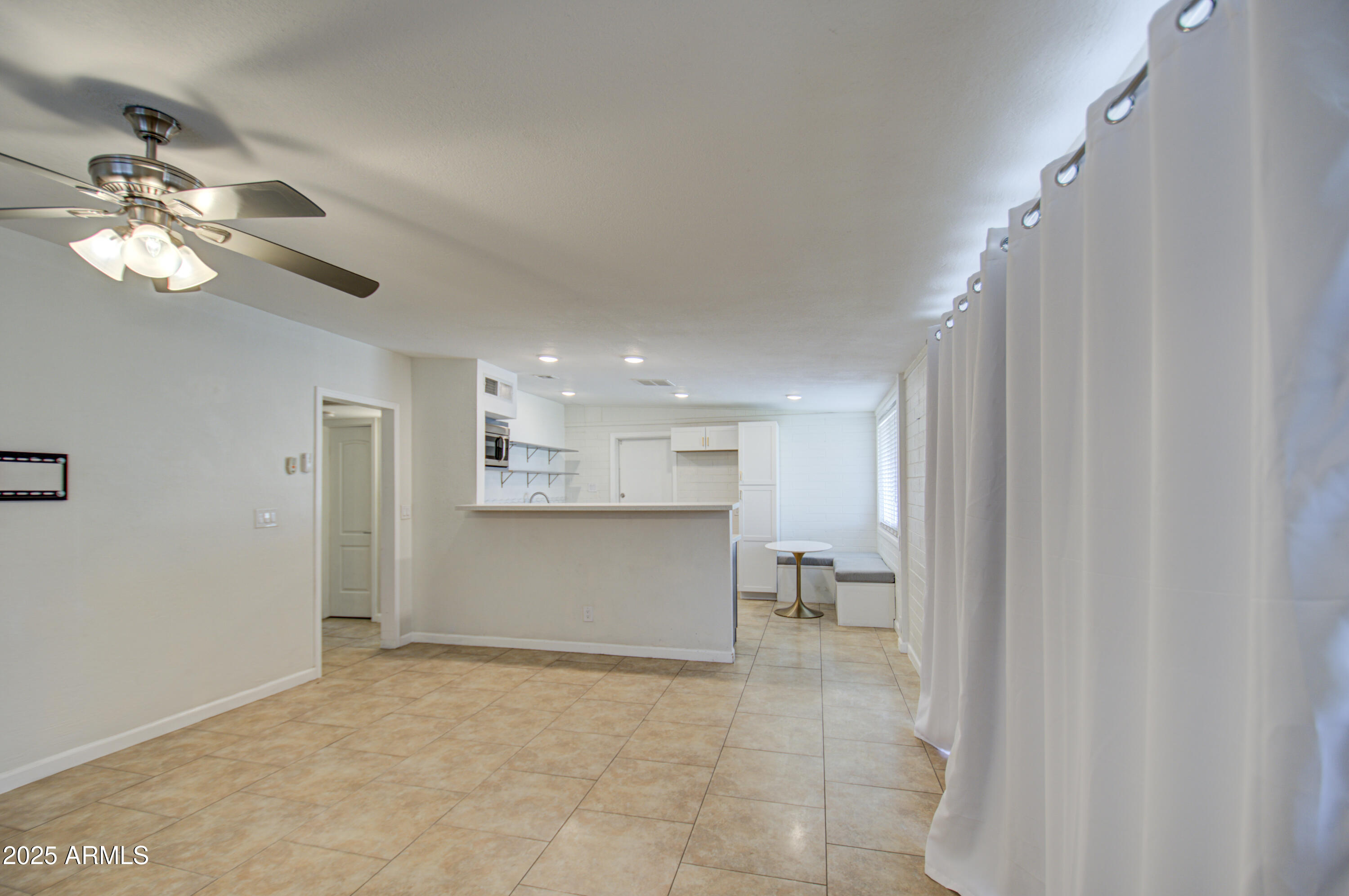 2937 East Osborn Road Phoenix, AZ 85016 - Photo 5 of 59 a view of kitchen and hallway with a chandelier