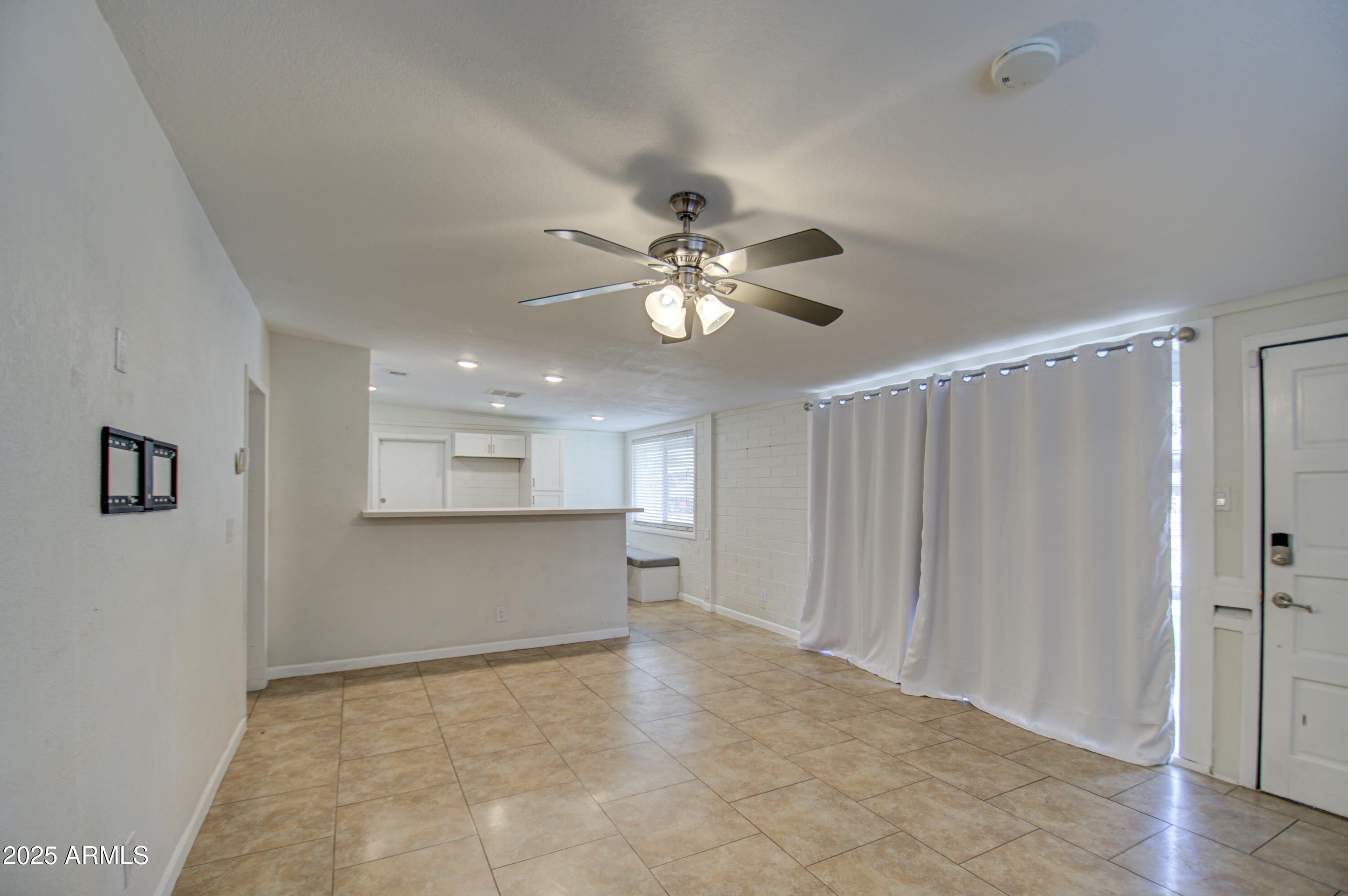 2937 East Osborn Road Phoenix, AZ 85016 - Photo 7 of 59 a view of an empty room with a ceiling fan