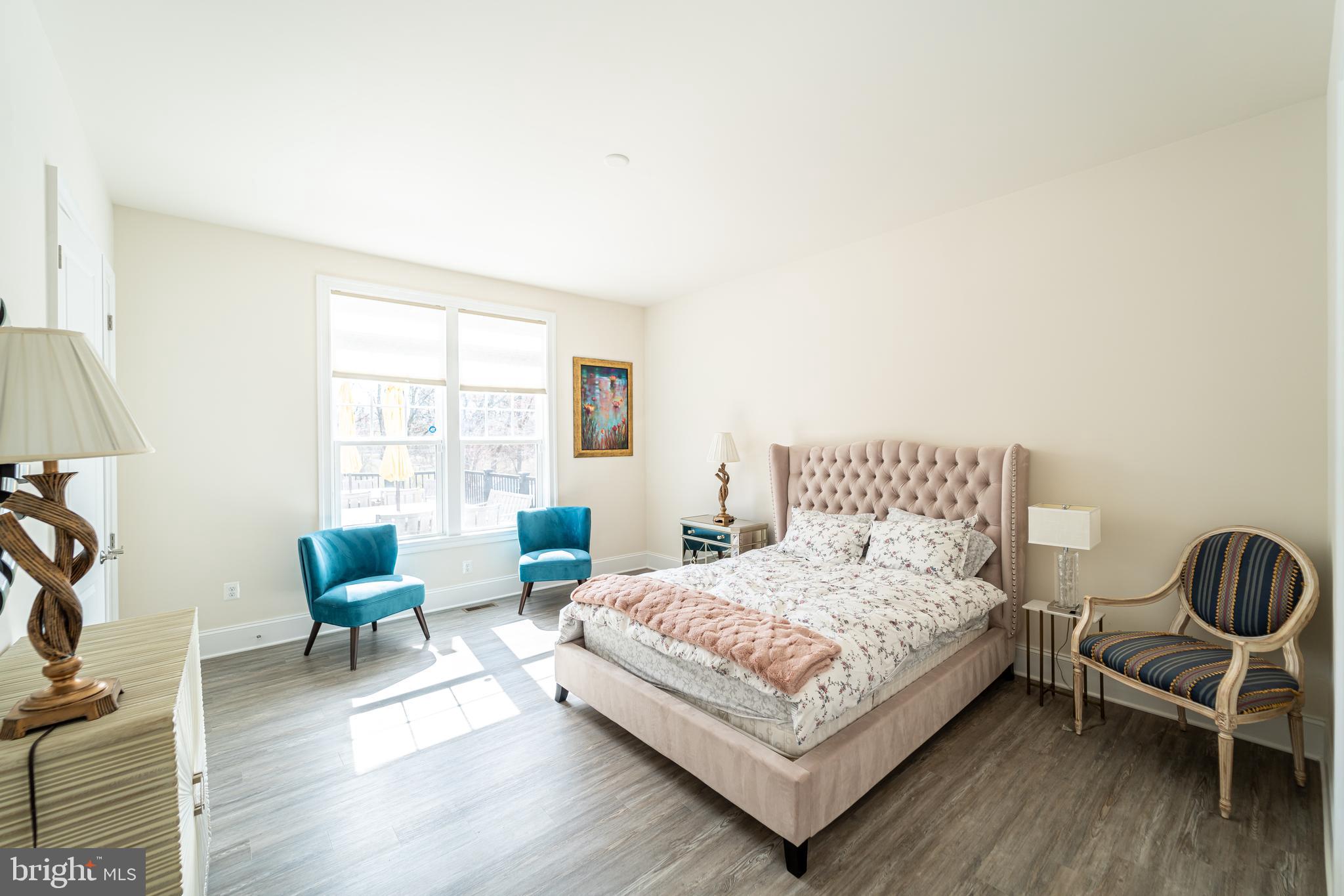 1059 Marmion Drive Herndon, VA 20170 - Photo 39 of 92 a bedroom with a bed a chair and a large window