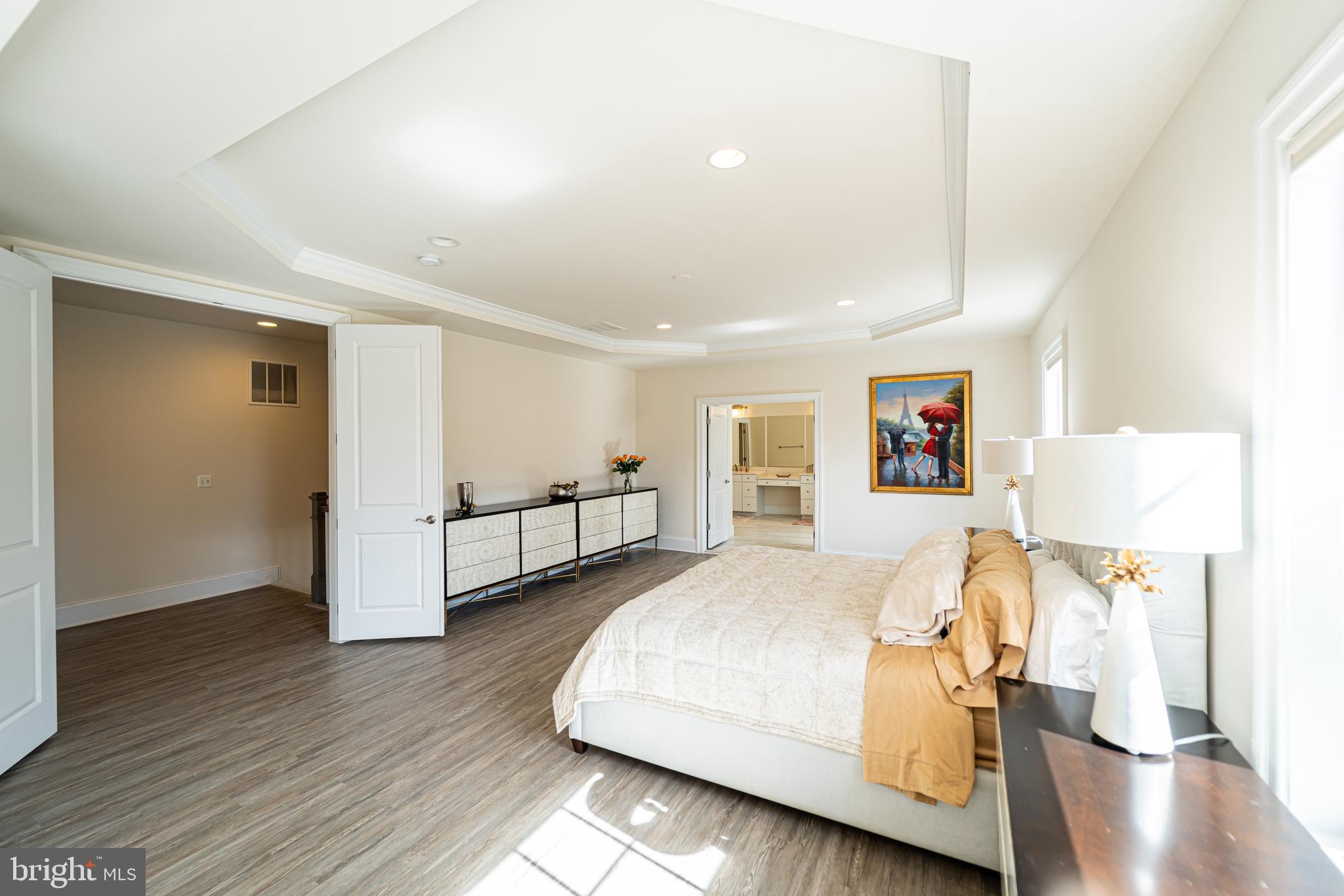 1059 Marmion Drive Herndon, VA 20170 - Photo 44 of 92 a spacious bedroom with a bed and a table in it