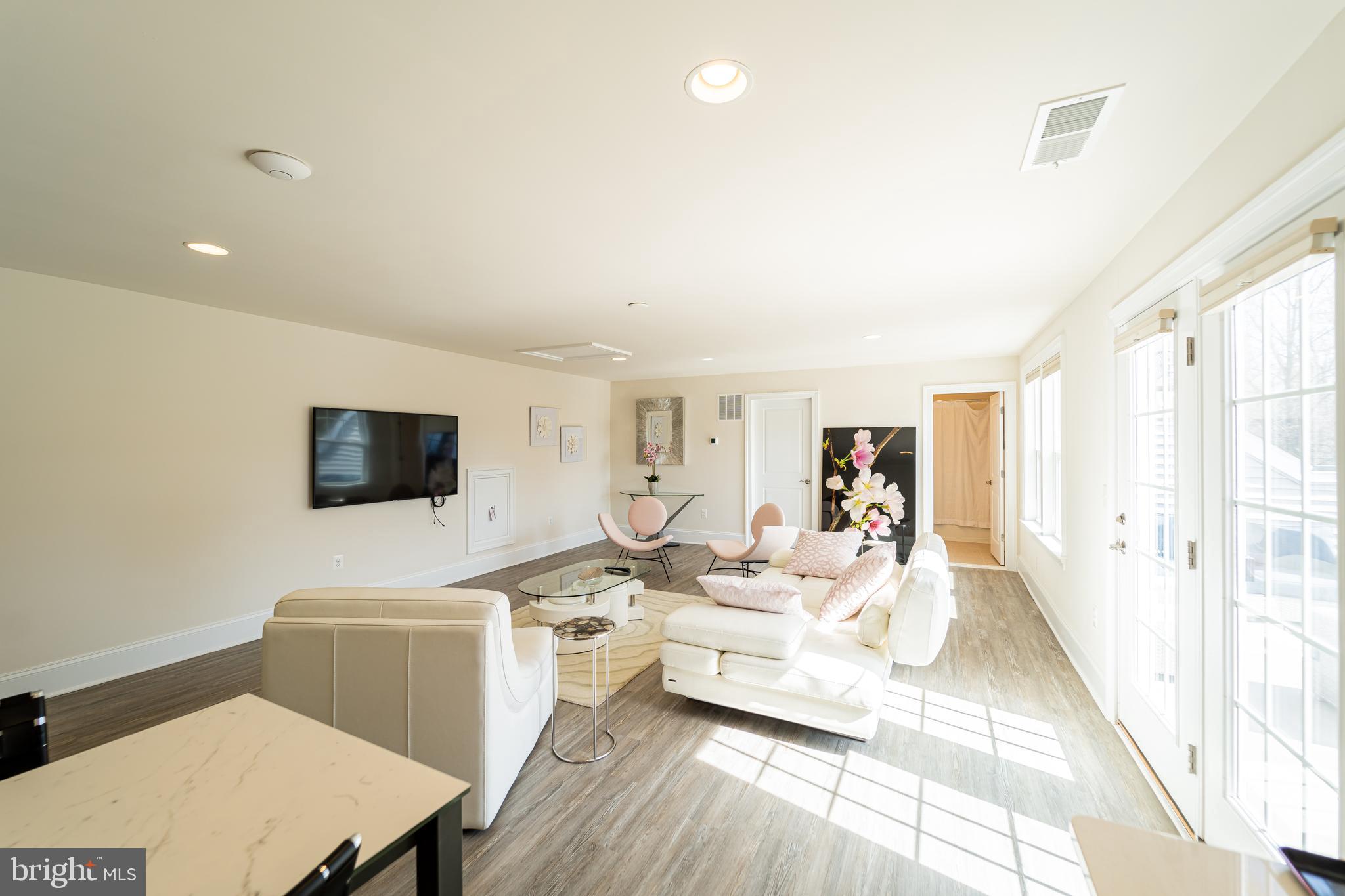 1059 Marmion Drive Herndon, VA 20170 - Photo 70 of 92 a living room with furniture a flat screen tv and a refrigerator
