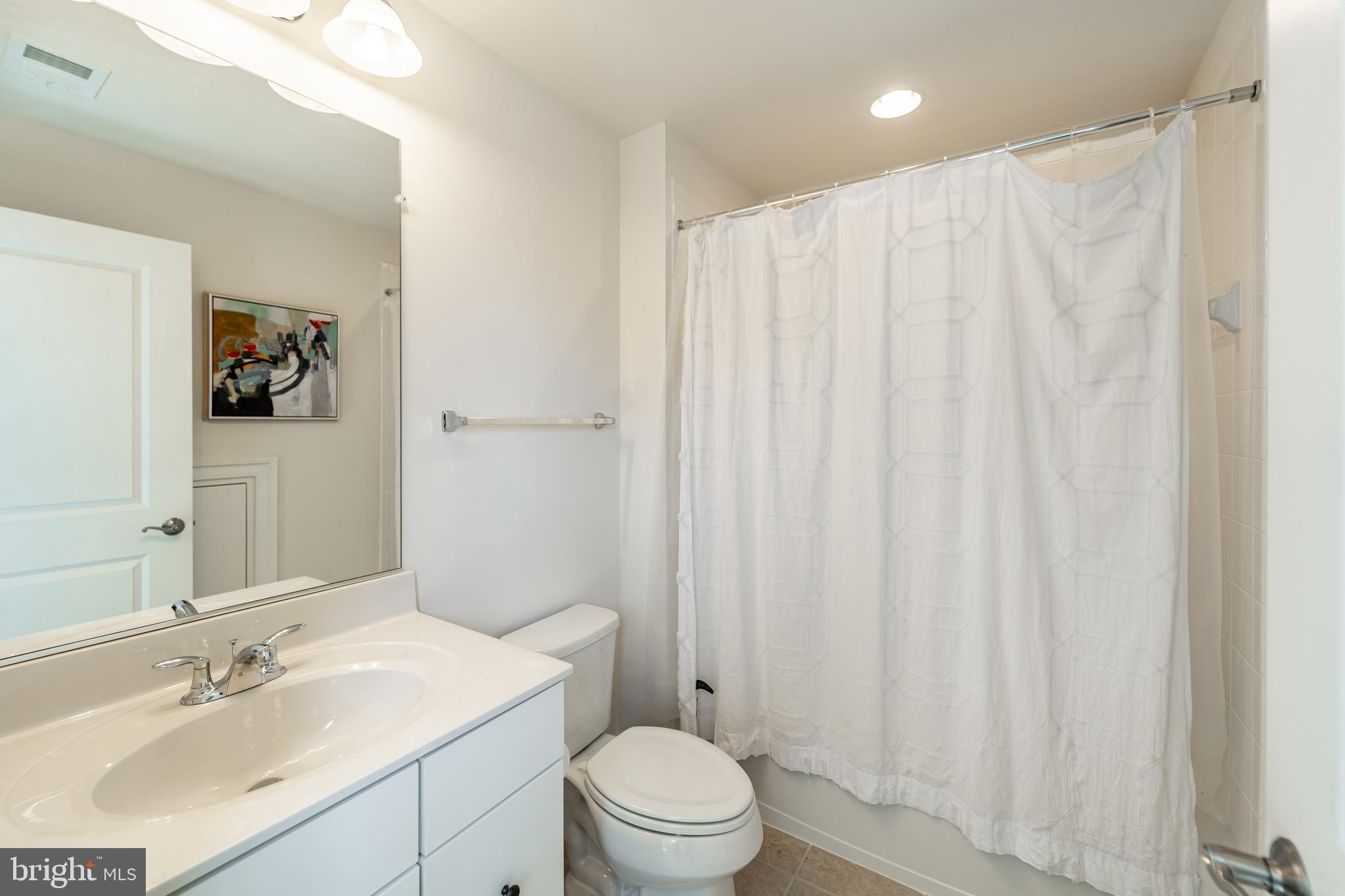 1059 Marmion Drive Herndon, VA 20170 - Photo 74 of 92 a bathroom with a sink a toilet and shower curtain