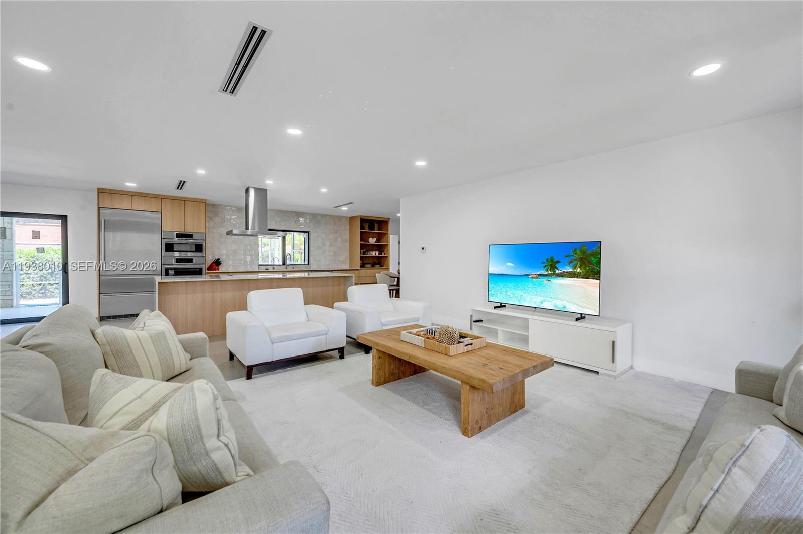 13407 Southwest 59th Avenue Pinecrest, FL 33156 - Photo 13 of 50 a living room with furniture and a flat screen tv