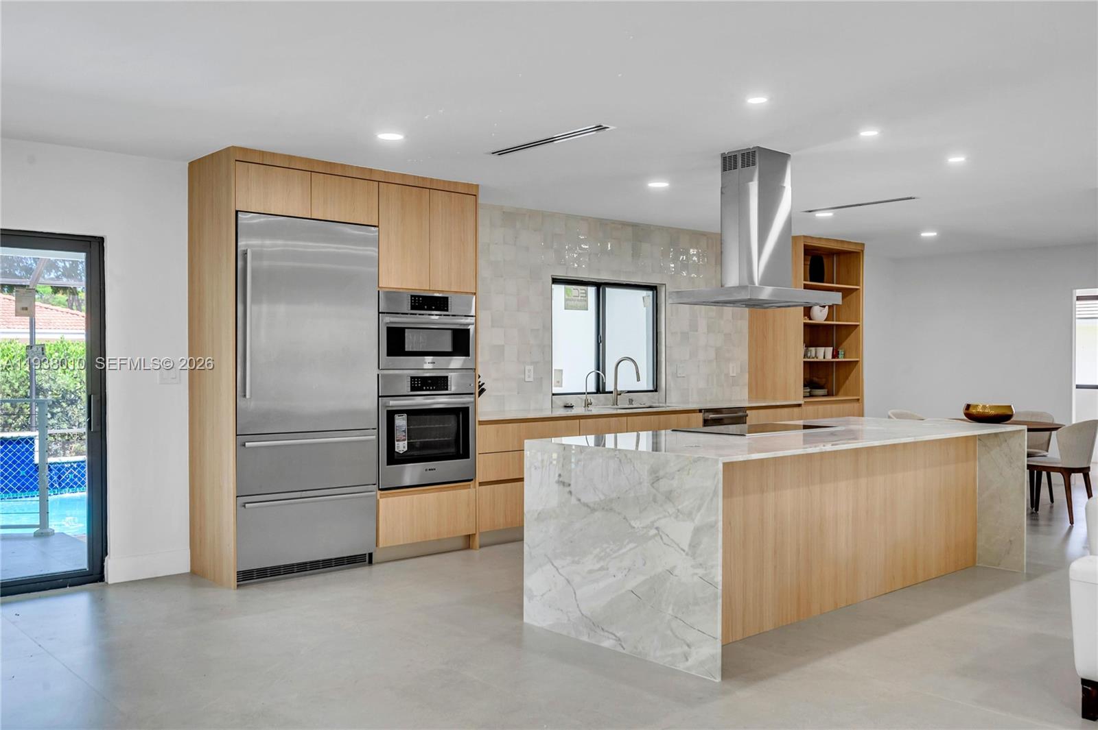 13407 Southwest 59th Avenue Pinecrest, FL 33156 - Photo 20 of 50 a large kitchen with stainless steel appliances kitchen island a large counter top and a sink