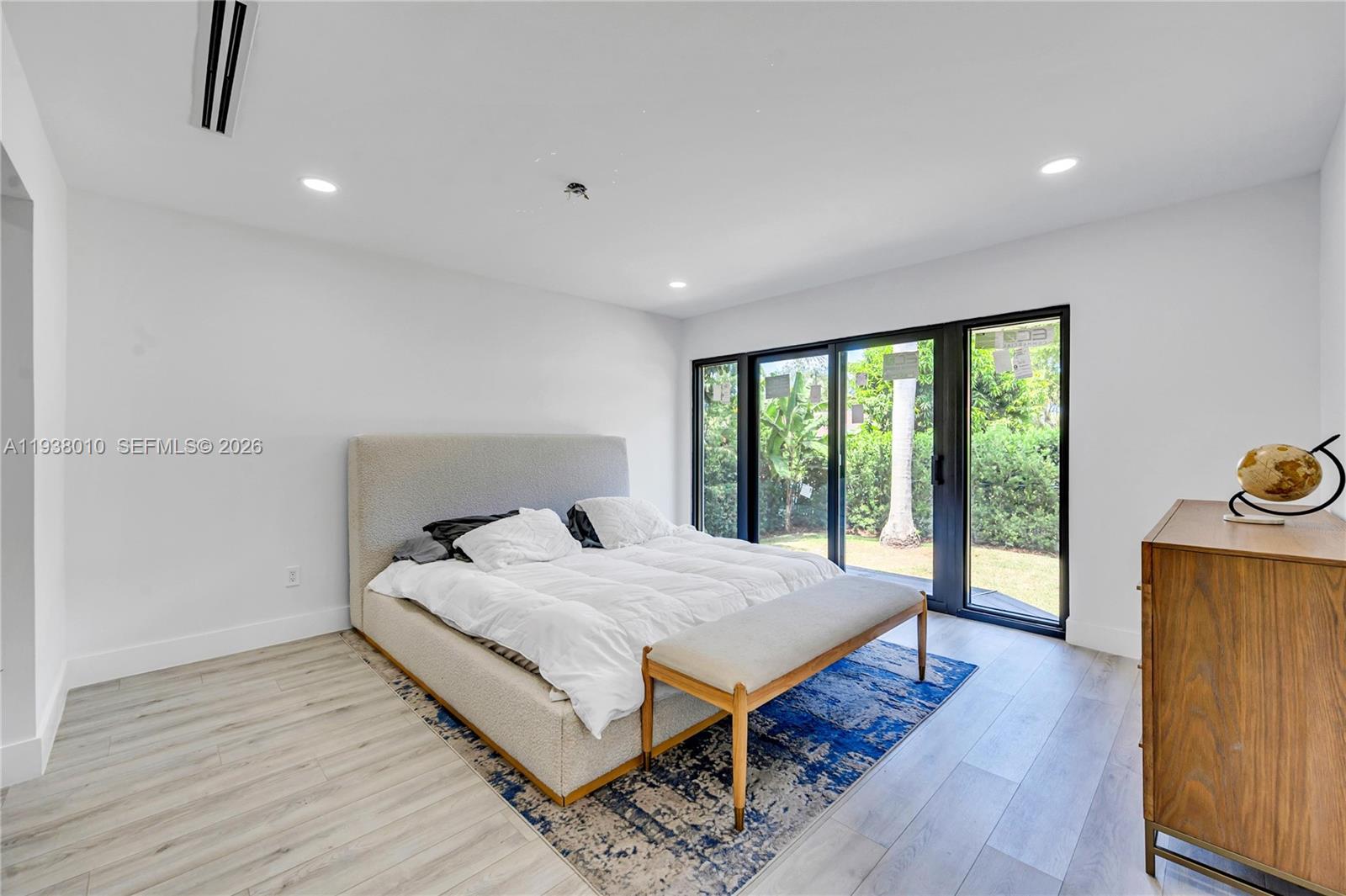 13407 Southwest 59th Avenue Pinecrest, FL 33156 - Photo 25 of 50 a bedroom with a bed and wooden floor