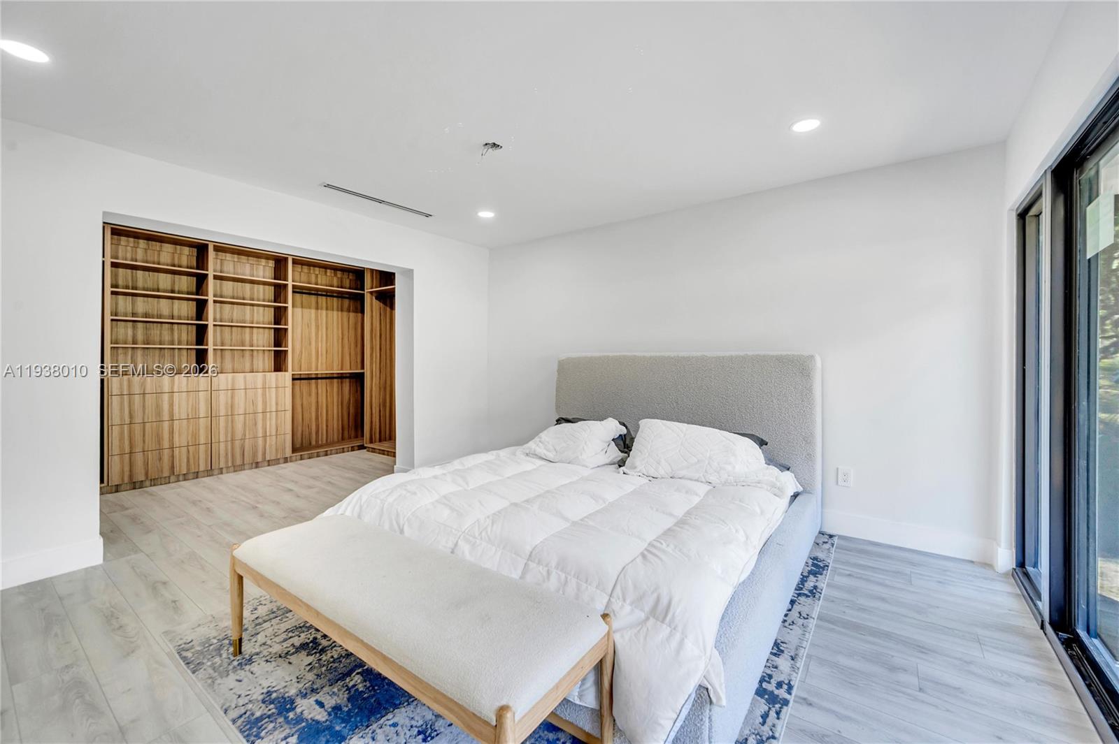 13407 Southwest 59th Avenue Pinecrest, FL 33156 - Photo 27 of 50 a bed sitting in a spacious bedroom next to a window
