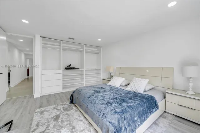 a bedroom with a large bed and a dresser