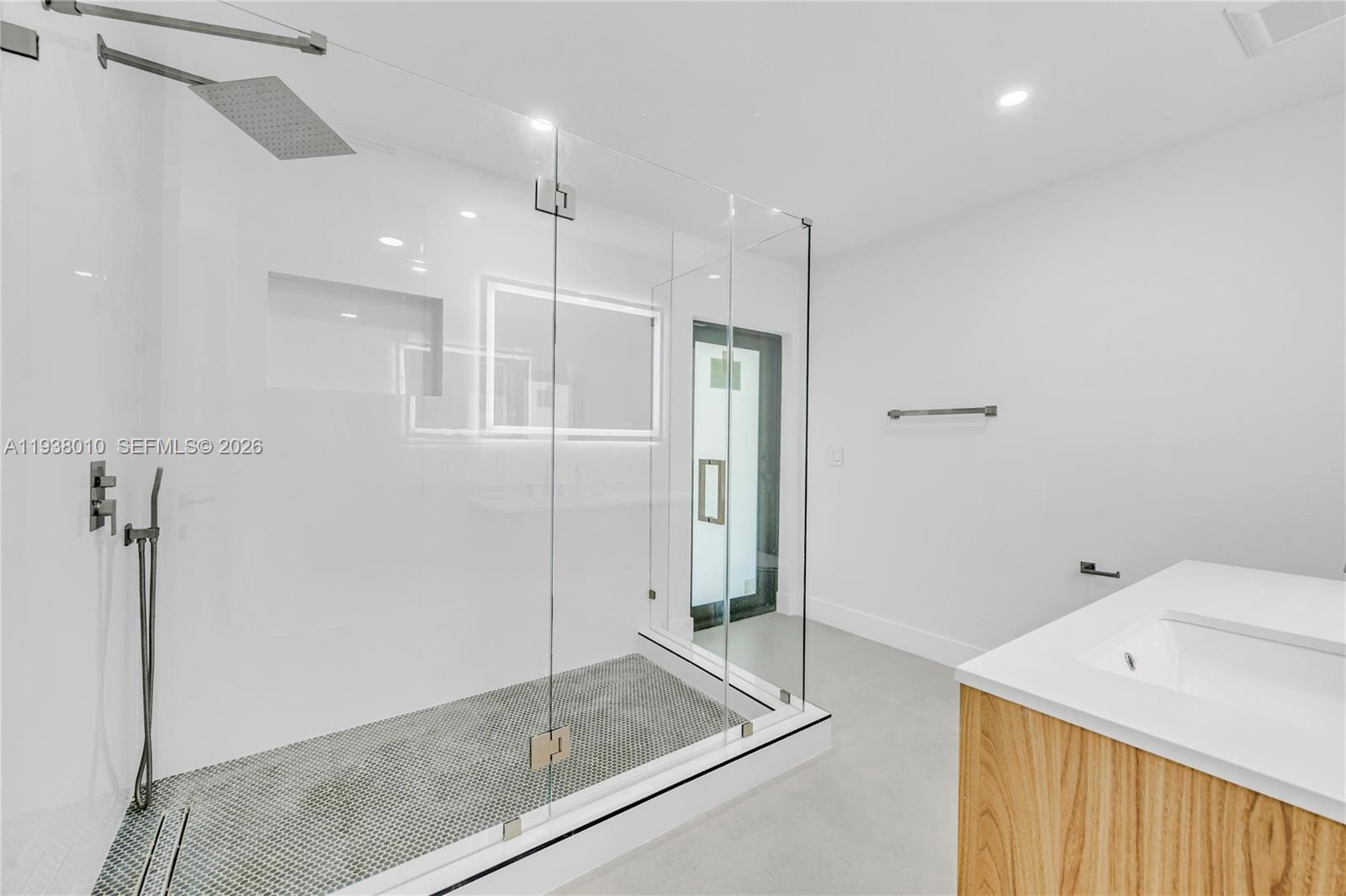 13407 Southwest 59th Avenue Pinecrest, FL 33156 - Photo 42 of 50 a bathroom with a shower and a sink