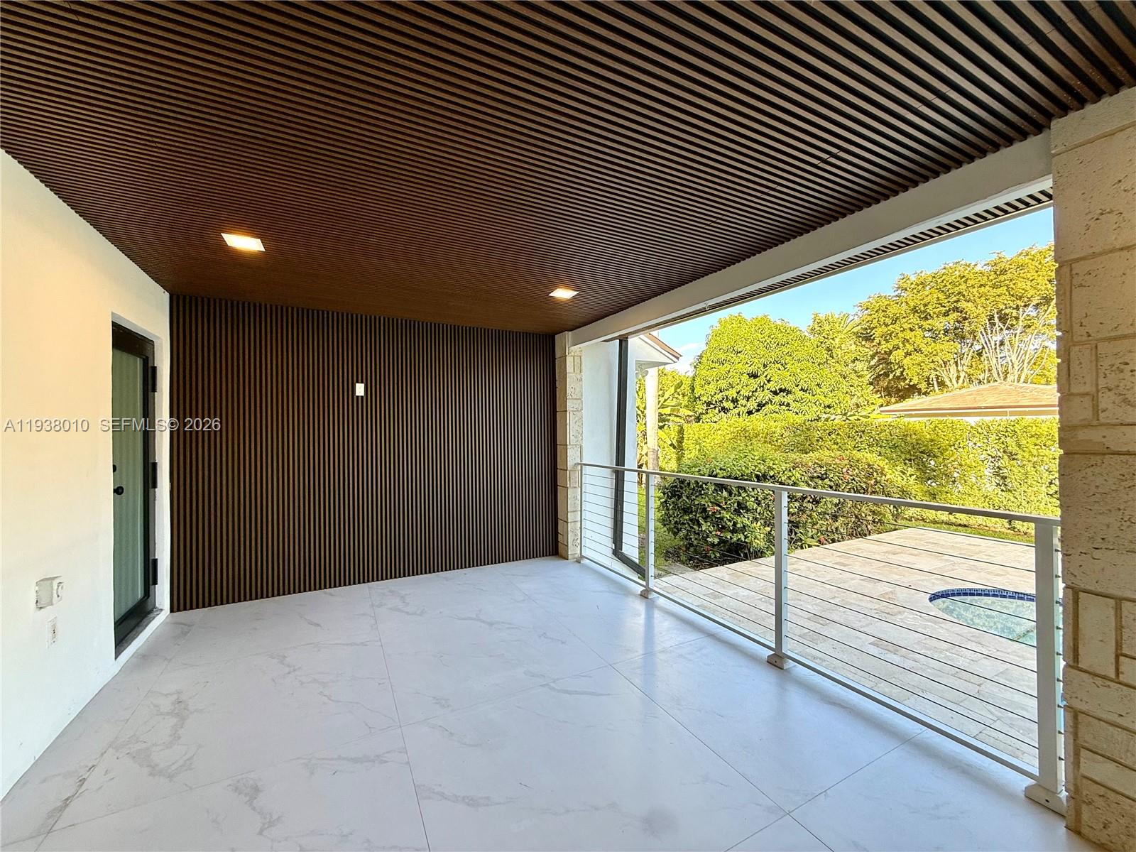 13407 Southwest 59th Avenue Pinecrest, FL 33156 - Photo 45 of 50 a view of an empty room with wooden floor and fence