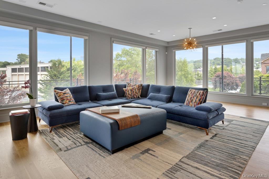 18 Rivers Edge Drive, Unit 211 Tarrytown, NY 10591 - Photo 4 of 30 a living room with furniture and large windows