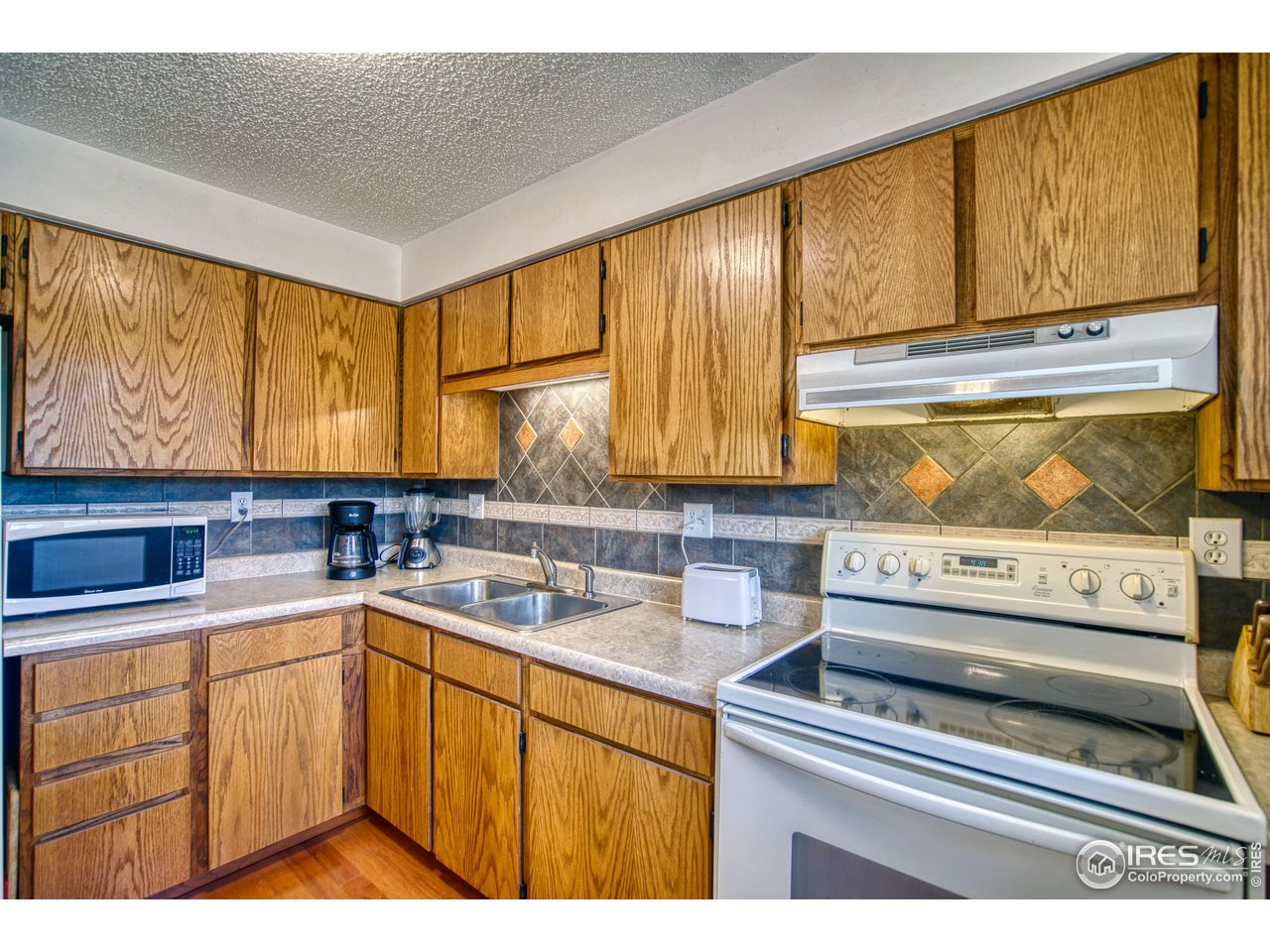725 Bruce Drive Berthoud, CO 80513 - Photo 11 of 21 a kitchen with a sink and cabinets