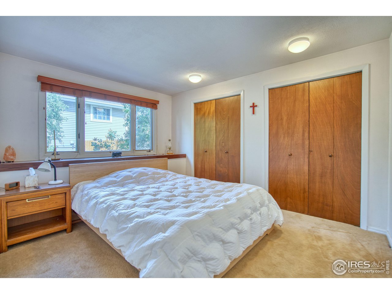 725 Bruce Drive Berthoud, CO 80513 - Photo 12 of 21 a bedroom with a bed and a large window