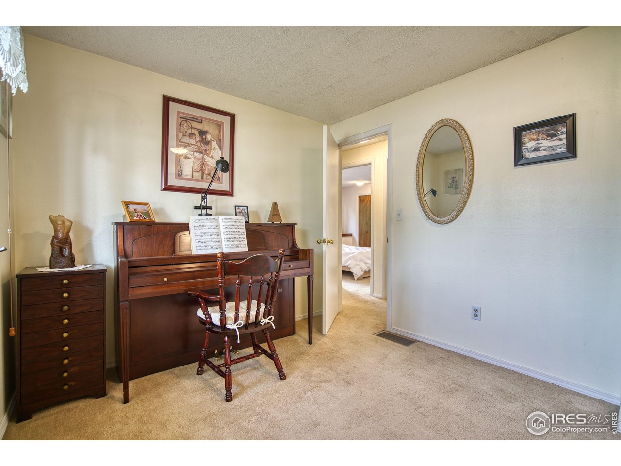 725 Bruce Drive Berthoud, CO 80513 - Photo 14 of 21 a workspace with furniture and paintings on the wall