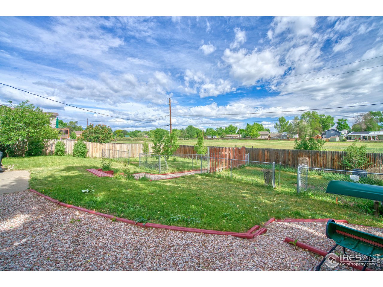 725 Bruce Drive Berthoud, CO 80513 - Photo 16 of 21 a view of a garden with a building in the background