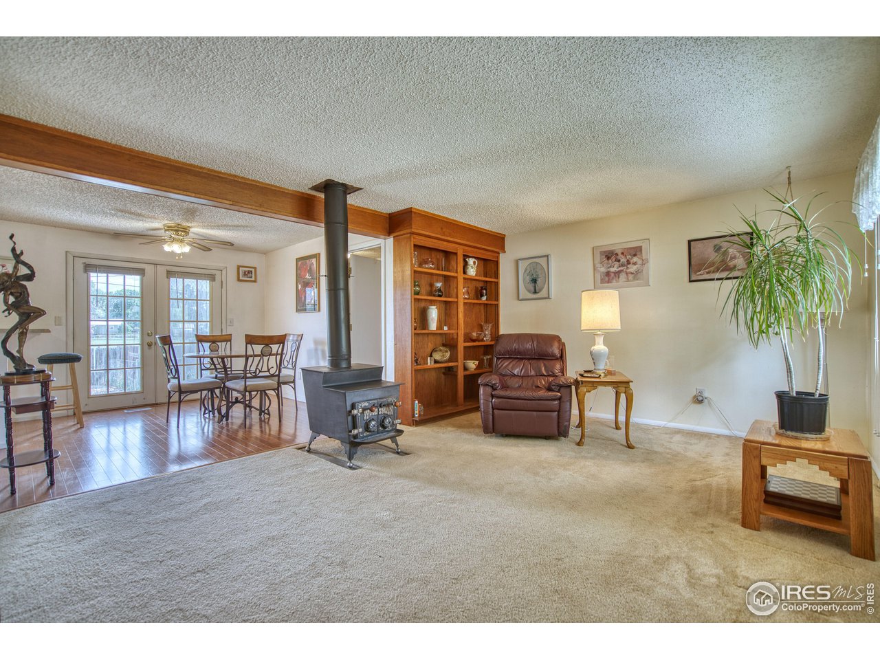 725 Bruce Drive Berthoud, CO 80513 - Photo 5 of 21 a living room with furniture and a dining table with wooden floor