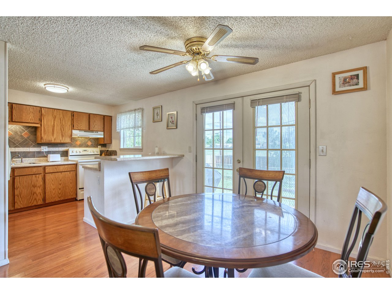 725 Bruce Drive Berthoud, CO 80513 - Photo 8 of 21 a dining room with furniture a window and wooden floor