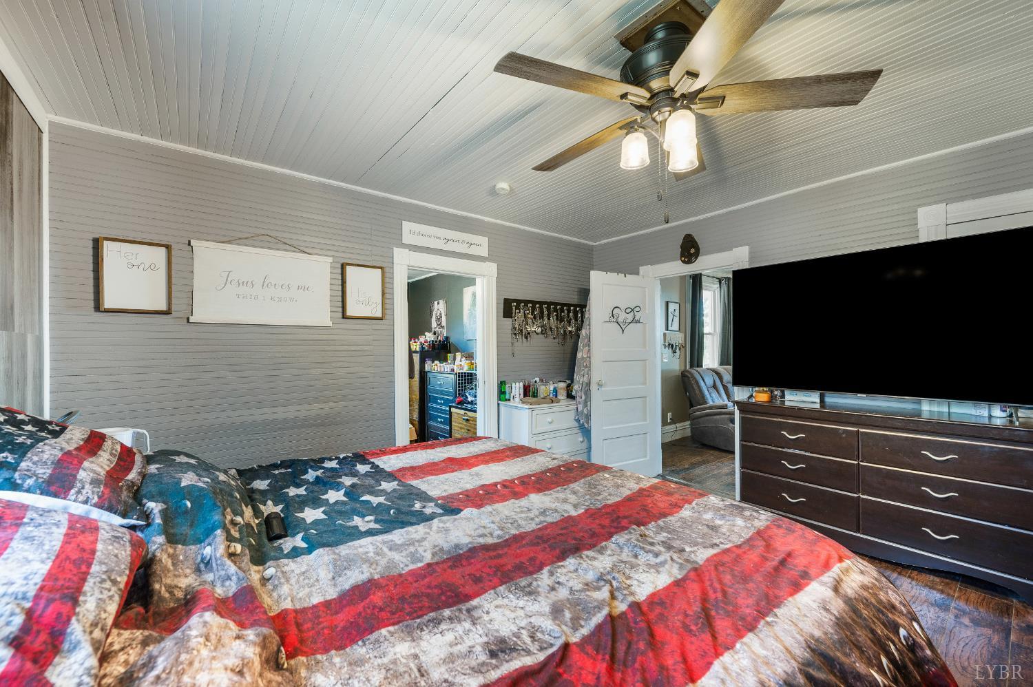 342 Toll Gate Road Concord, VA 24538 - Photo 13 of 48 a bedroom with a bed and a flat screen tv