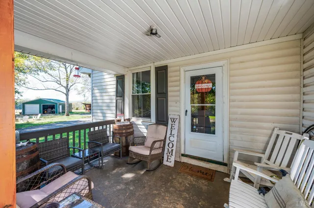 a view of a patio with a table and chairs