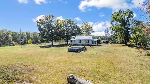 a roof deck with wooden floor and furniture