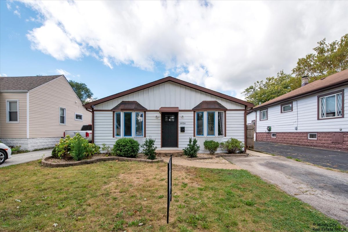 14914 Avers Avenue Midlothian, IL 60445 - Photo 1 of 22 a front view of a house with garden