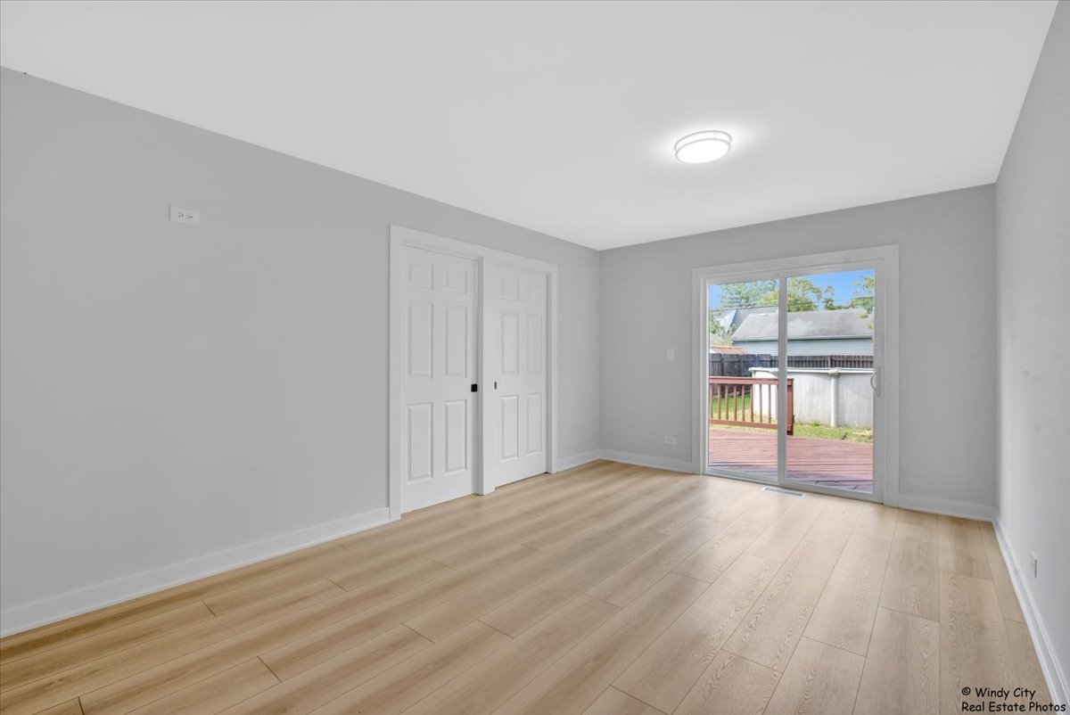 14914 Avers Avenue Midlothian, IL 60445 - Photo 11 of 22 a view of empty room with wooden floor and fan