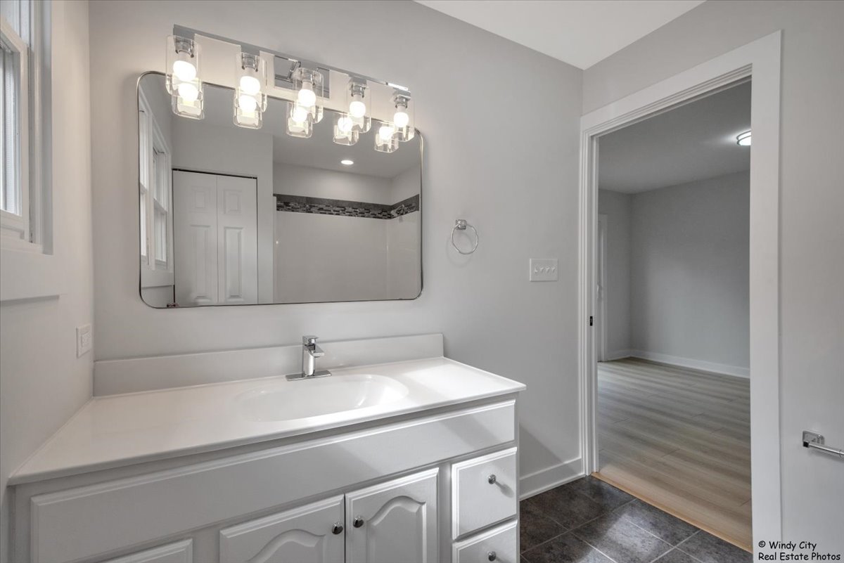 14914 Avers Avenue Midlothian, IL 60445 - Photo 14 of 22 a bathroom with a sink and a mirror