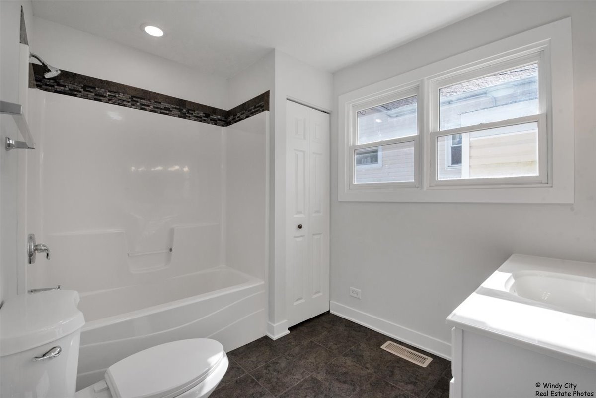 14914 Avers Avenue Midlothian, IL 60445 - Photo 15 of 22 a bathroom with a bathtub a toilet and a shower