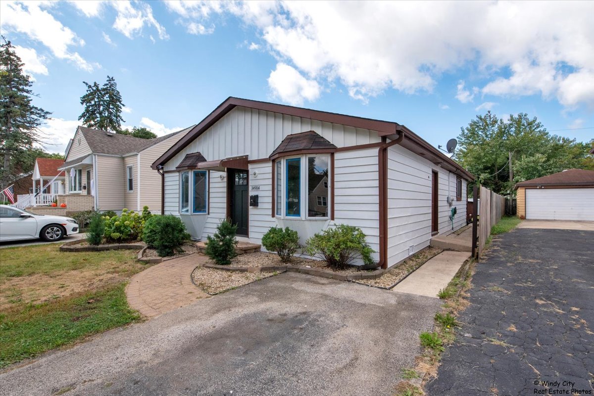 14914 Avers Avenue Midlothian, IL 60445 - Photo 2 of 22 a front view of a house with garden