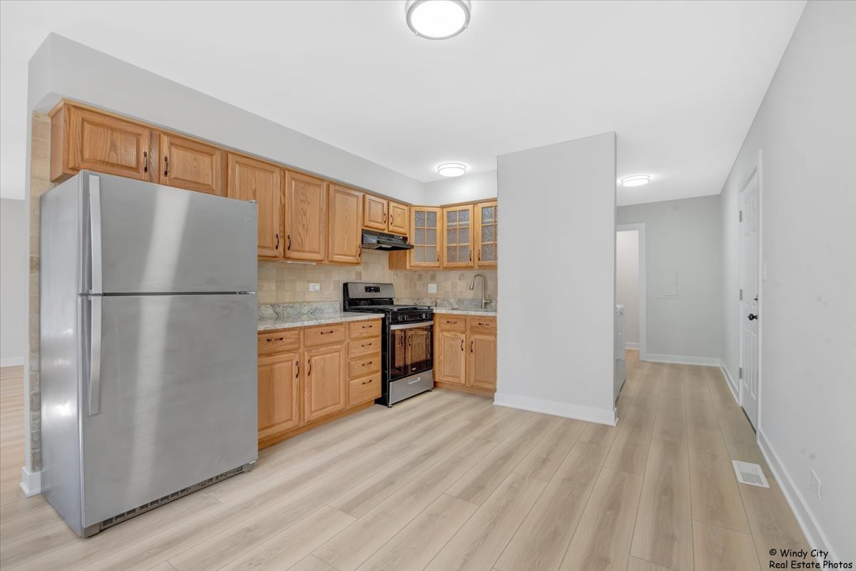 14914 Avers Avenue Midlothian, IL 60445 - Photo 3 of 22 a kitchen with a refrigerator and a stove top oven