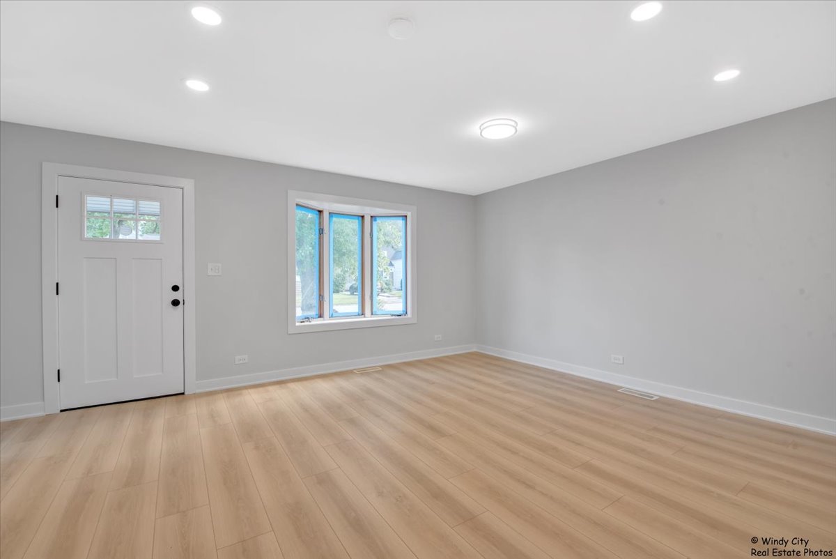 14914 Avers Avenue Midlothian, IL 60445 - Photo 8 of 22 wooden floor in an empty room with a window