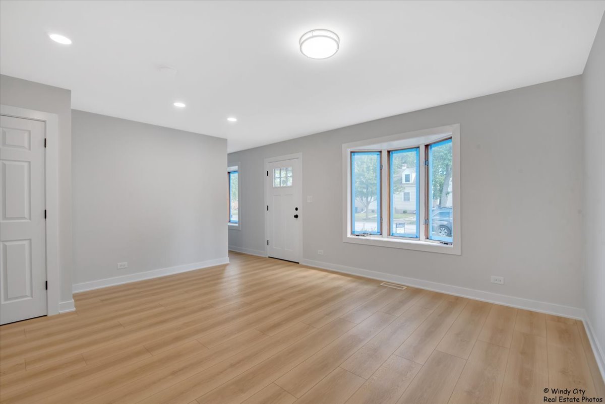 14914 Avers Avenue Midlothian, IL 60445 - Photo 9 of 22 an empty room with wooden floor and windows