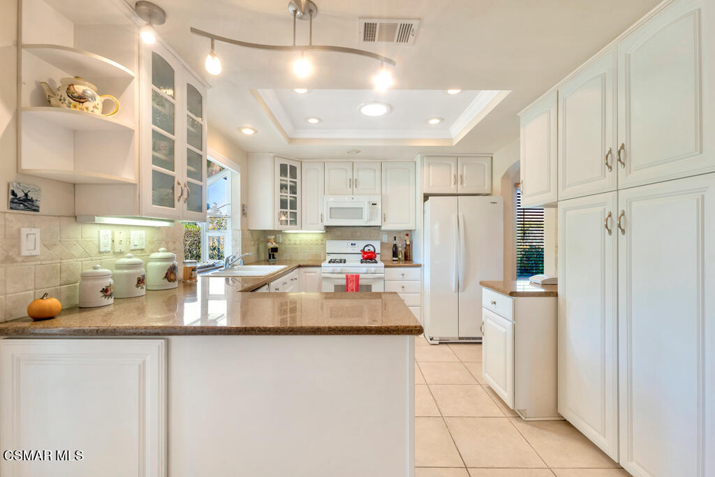 4331 Mill Valley Road Moorpark, CA 93021 - Photo 12 of 40 a kitchen with refrigerator and cabinets