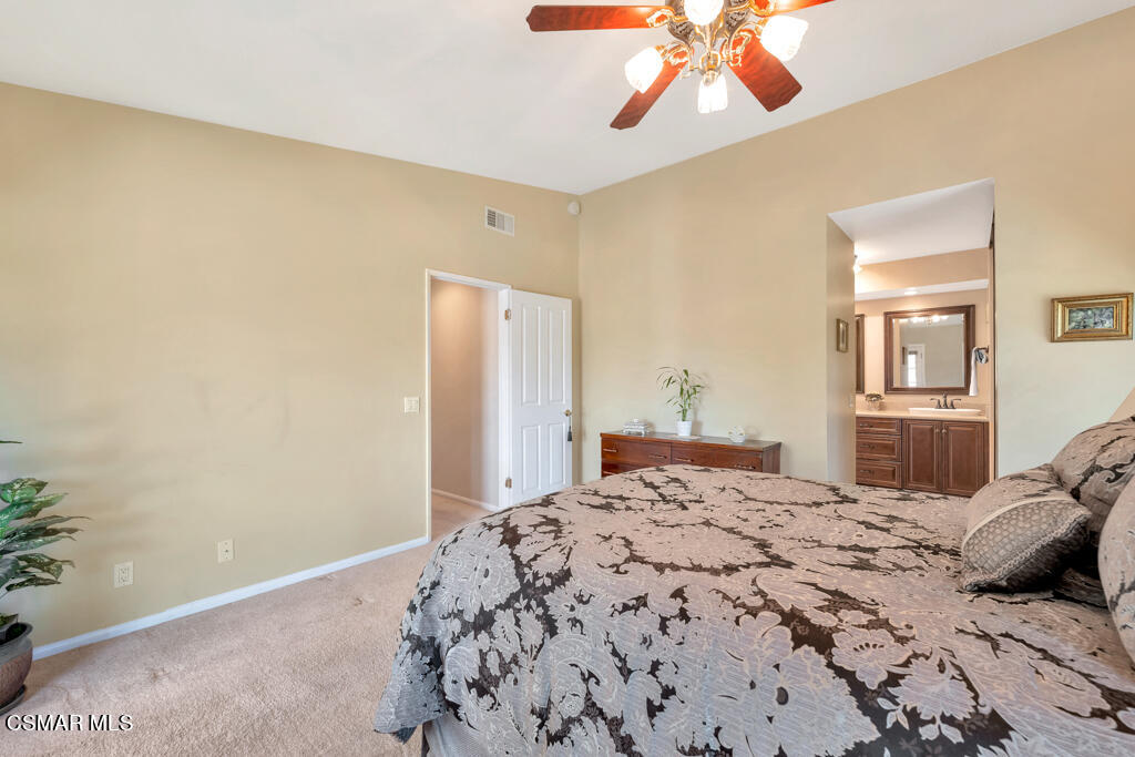 4331 Mill Valley Road Moorpark, CA 93021 - Photo 19 of 40 a bedroom with a bed and a chandelier