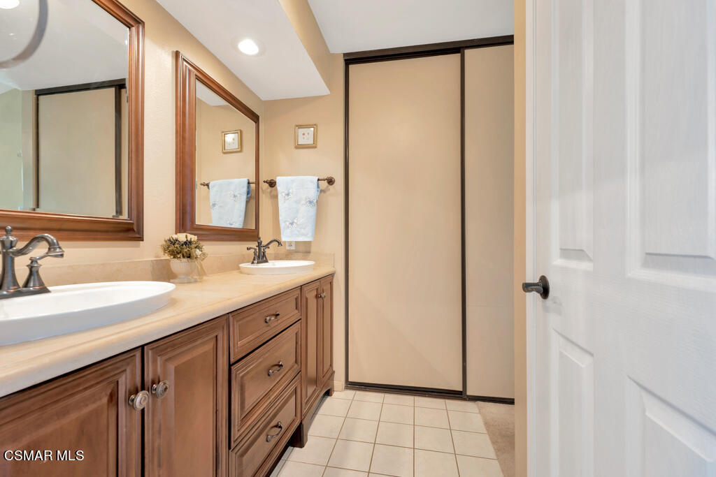 4331 Mill Valley Road Moorpark, CA 93021 - Photo 20 of 40 a spacious bathroom with a granite countertop sink a mirror and a