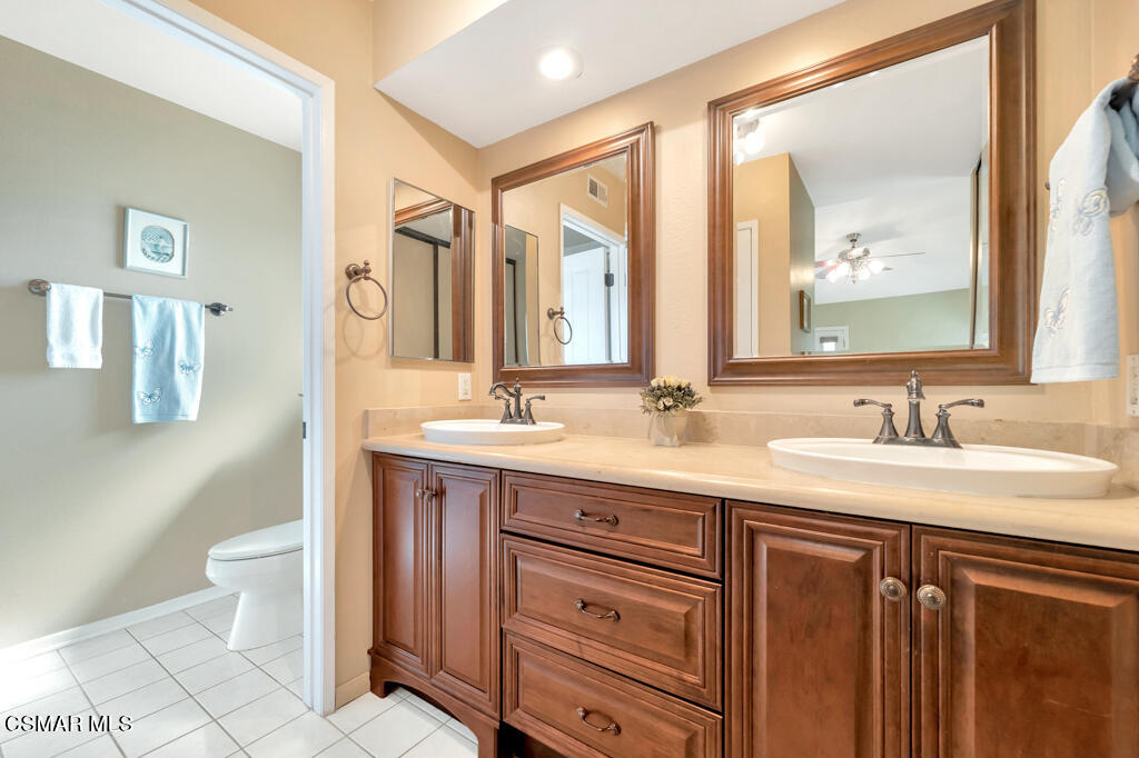 4331 Mill Valley Road Moorpark, CA 93021 - Photo 21 of 40 a bathroom with a granite countertop sink and a mirror