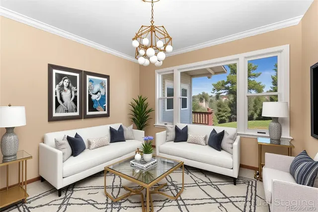 a living room with furniture and a chandelier